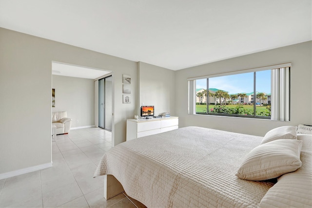 bedroom featuring baseboards and light tile patterned floors