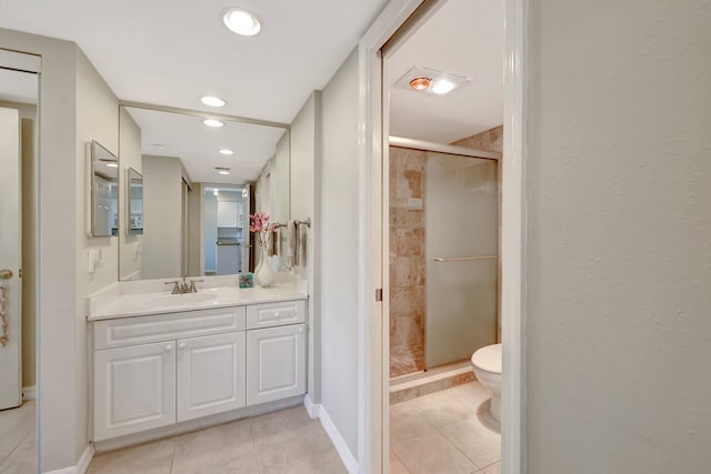 bathroom with a stall shower, baseboards, toilet, tile patterned floors, and vanity