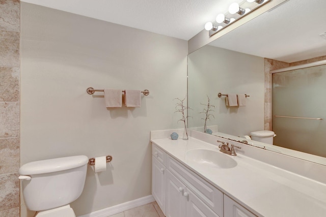 bathroom with baseboards, toilet, a shower with door, tile patterned flooring, and vanity