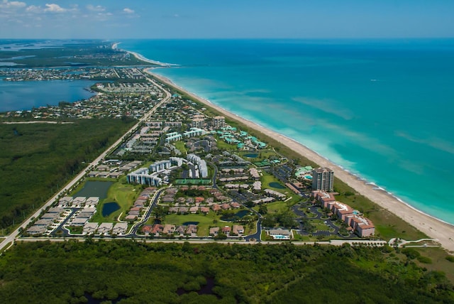 birds eye view of property with a water view and a view of the beach