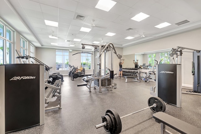 workout area featuring baseboards, visible vents, and a drop ceiling