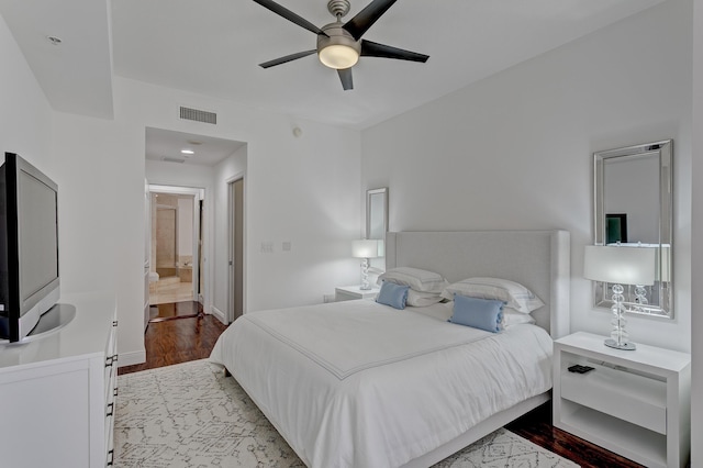 bedroom with ensuite bath, ceiling fan, and light wood-type flooring