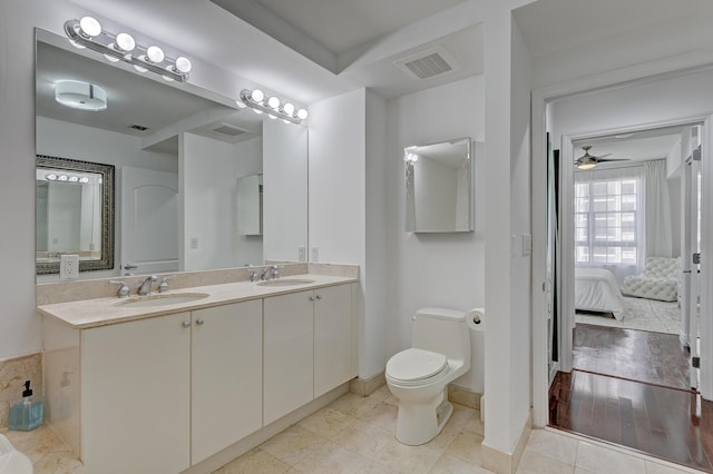 bathroom with vanity, ceiling fan, tile patterned flooring, and toilet