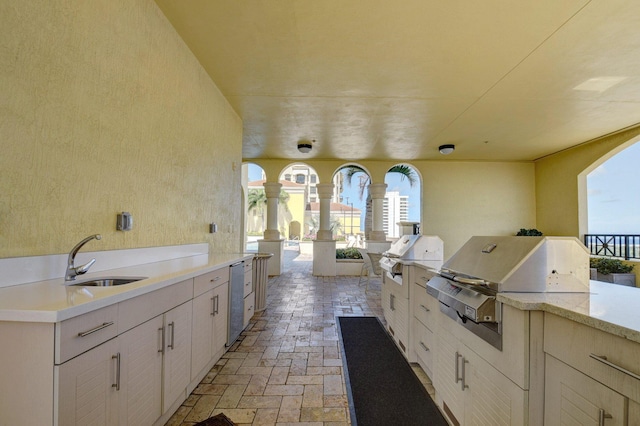 view of patio / terrace featuring area for grilling, a grill, and sink