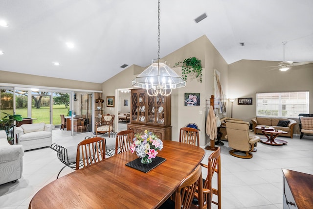 dining space featuring light tile patterned flooring, ceiling fan with notable chandelier, and a wealth of natural light