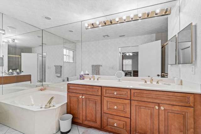 bathroom featuring plus walk in shower, vanity, and tile patterned floors