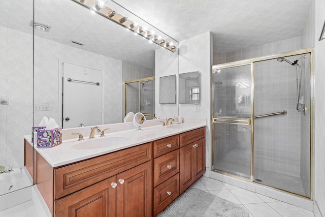 bathroom with vanity, tile patterned floors, and a shower with door