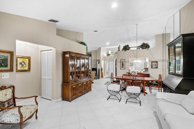 interior space featuring high vaulted ceiling and an inviting chandelier