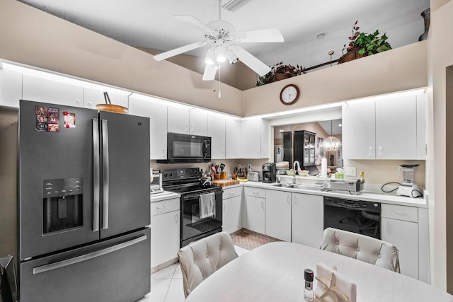 kitchen with white cabinetry, pendant lighting, light tile patterned floors, and black appliances