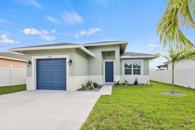 view of front facade with stucco siding, an attached garage, a front yard, fence, and driveway