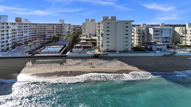 view of property with a beach view and a water view