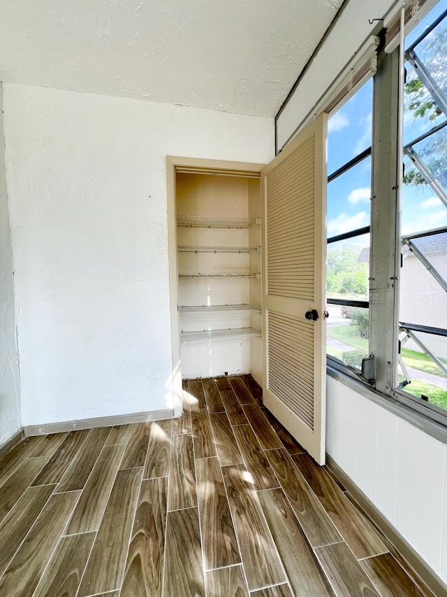 unfurnished room with a textured ceiling