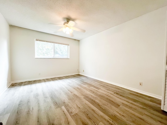 unfurnished room with light hardwood / wood-style floors, a textured ceiling, and ceiling fan