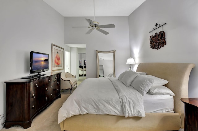 bedroom featuring light carpet and ceiling fan