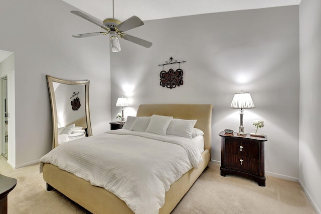 bedroom featuring ceiling fan, vaulted ceiling, and light carpet