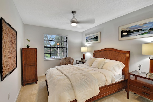 carpeted bedroom with a textured ceiling and ceiling fan