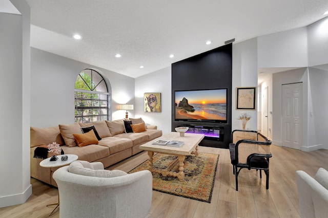 living room with lofted ceiling and light hardwood / wood-style flooring