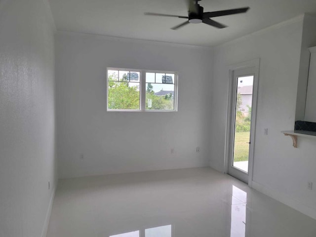 empty room featuring ornamental molding and ceiling fan