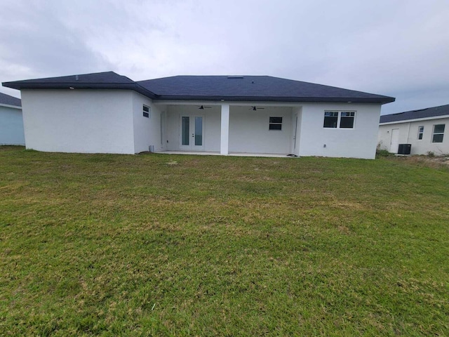 rear view of house featuring ceiling fan, a patio, central AC unit, and a lawn