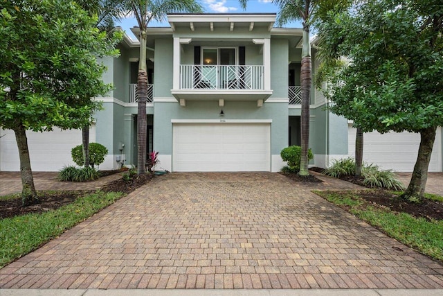 view of front of home featuring a balcony and a garage