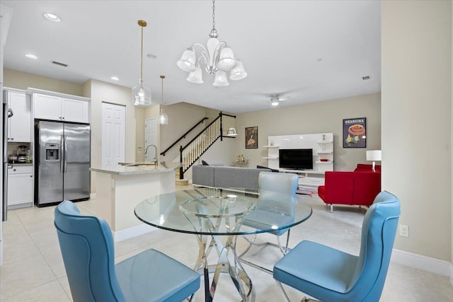 dining room featuring ceiling fan with notable chandelier and light tile patterned floors