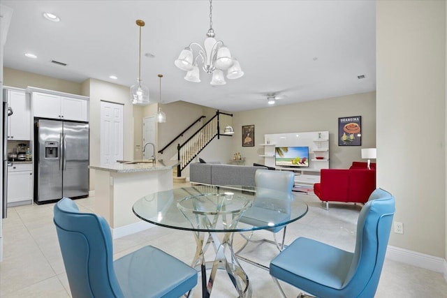 dining room with a chandelier and light tile patterned floors