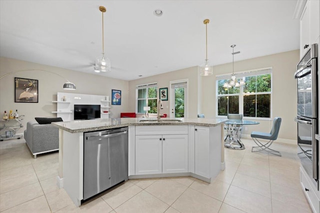 kitchen featuring sink, white cabinets, a kitchen island with sink, and stainless steel appliances