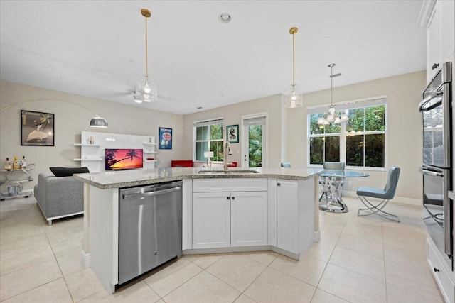 kitchen featuring white cabinets, an island with sink, appliances with stainless steel finishes, and sink