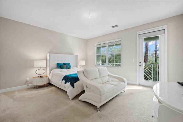 bedroom with light colored carpet, multiple windows, and access to exterior