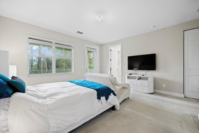 bedroom featuring light colored carpet