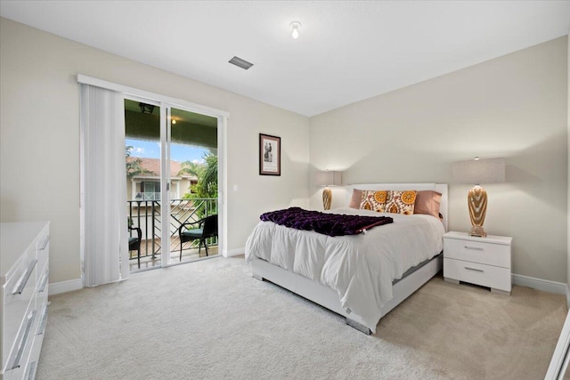 bedroom with light carpet and access to exterior