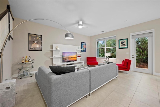 living room featuring light tile patterned floors and ceiling fan