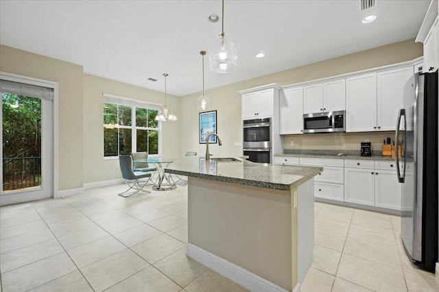 kitchen featuring decorative light fixtures, sink, white cabinetry, and stainless steel appliances