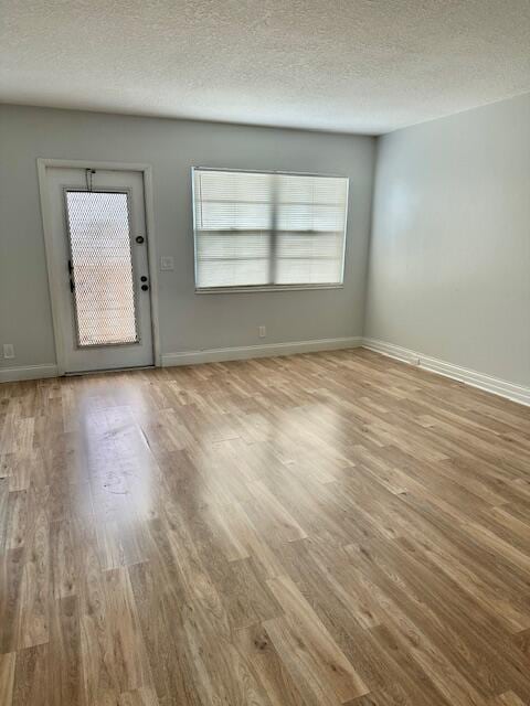 interior space featuring a textured ceiling and light hardwood / wood-style flooring