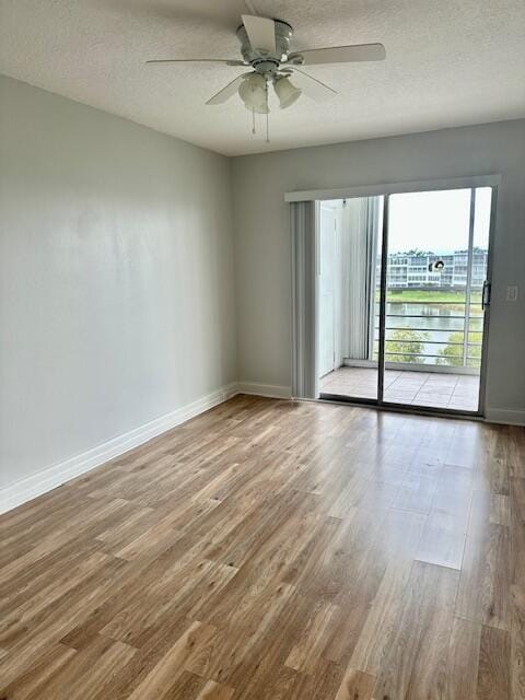 spare room with hardwood / wood-style floors, a textured ceiling, and ceiling fan