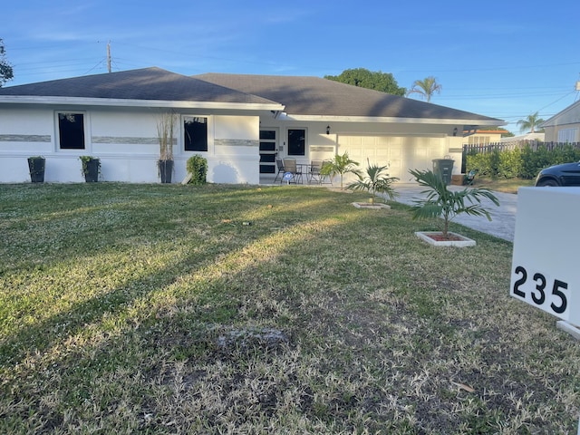 ranch-style home featuring a garage and a front lawn