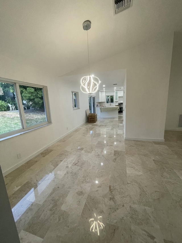 unfurnished dining area featuring a chandelier