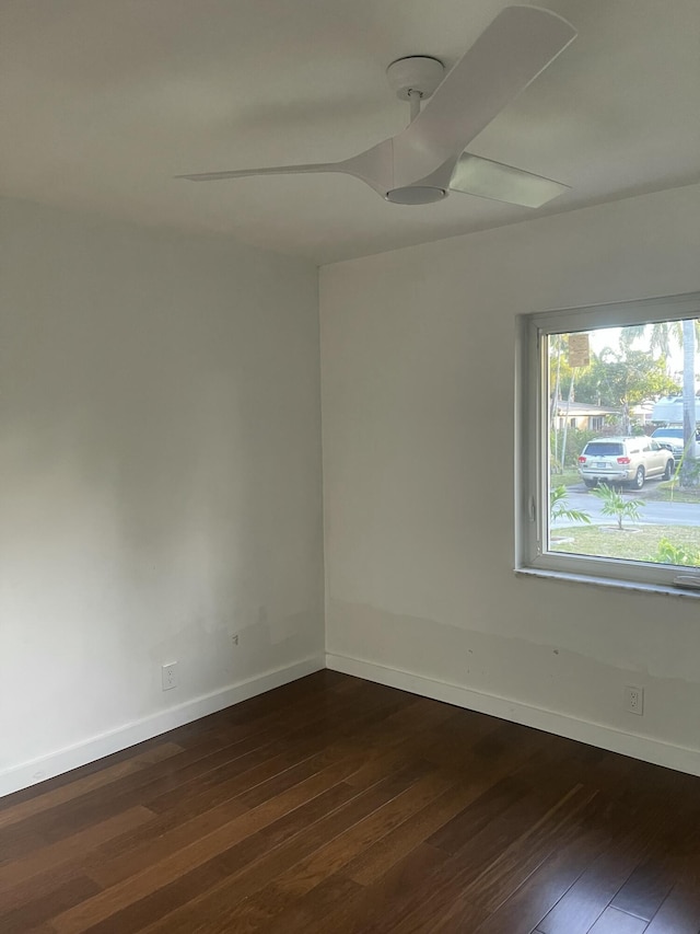 empty room with ceiling fan and dark hardwood / wood-style floors