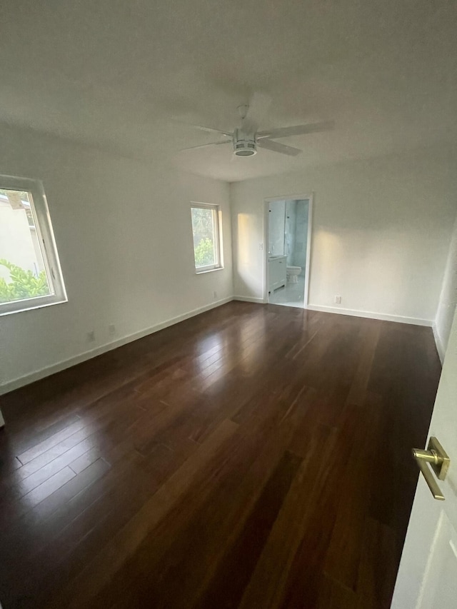 empty room with ceiling fan and dark hardwood / wood-style floors