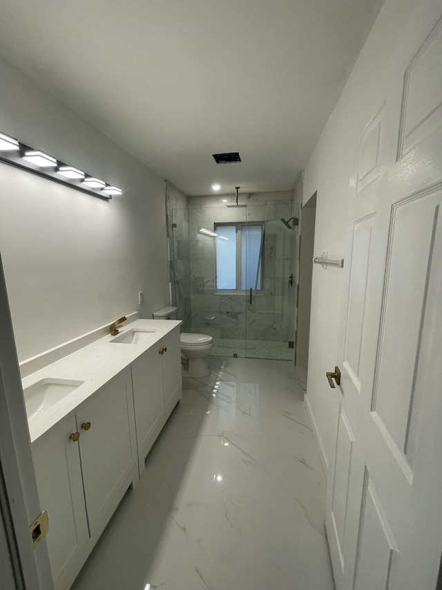 bathroom with a shower with shower door, toilet, and vanity