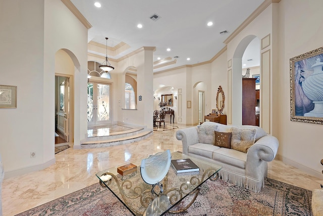 living room with crown molding and a towering ceiling