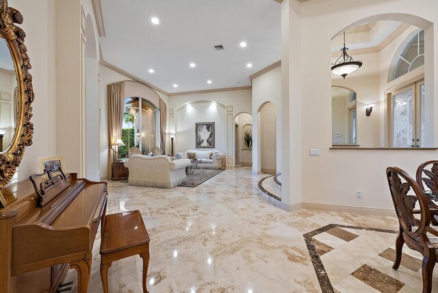 dining room featuring a notable chandelier, a tray ceiling, and ornamental molding