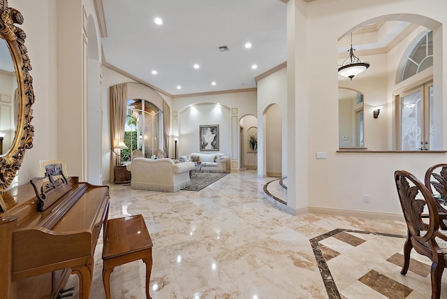 living room featuring crown molding and a towering ceiling