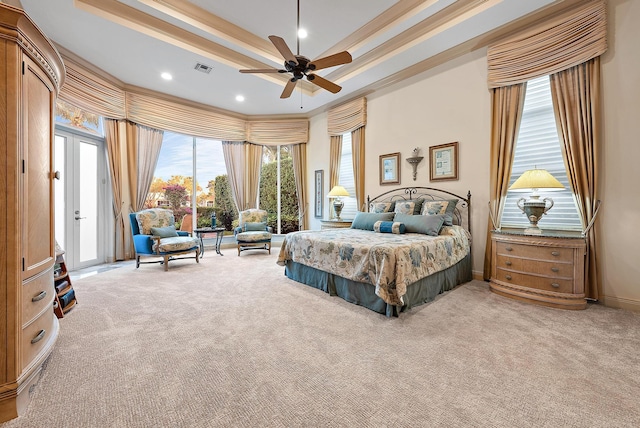 bedroom with french doors, light carpet, access to outside, a tray ceiling, and ceiling fan