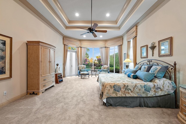 carpeted bedroom featuring crown molding, a tray ceiling, ceiling fan, access to exterior, and a high ceiling