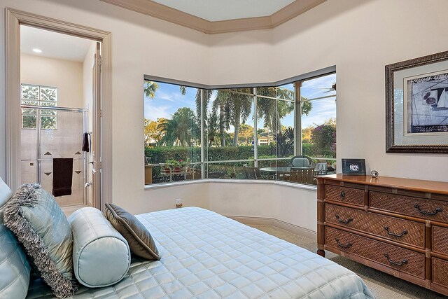 carpeted bedroom with ensuite bath, ornamental molding, a raised ceiling, and ceiling fan