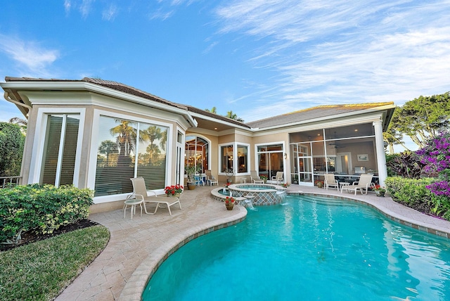 view of pool with a patio area, a sunroom, ceiling fan, and an in ground hot tub