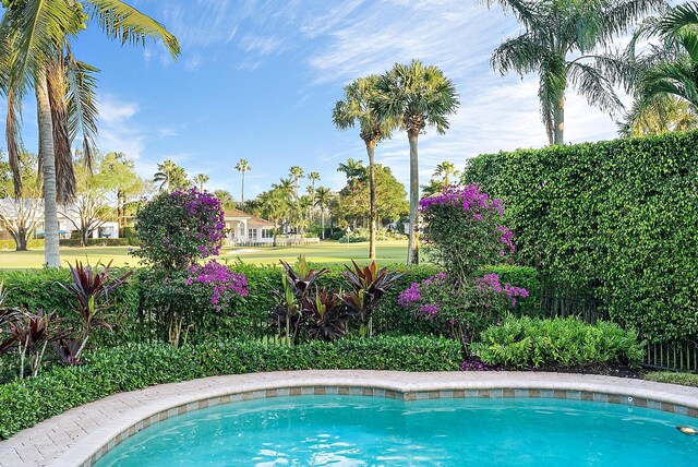 view of swimming pool with an in ground hot tub, a patio area, and a sunroom