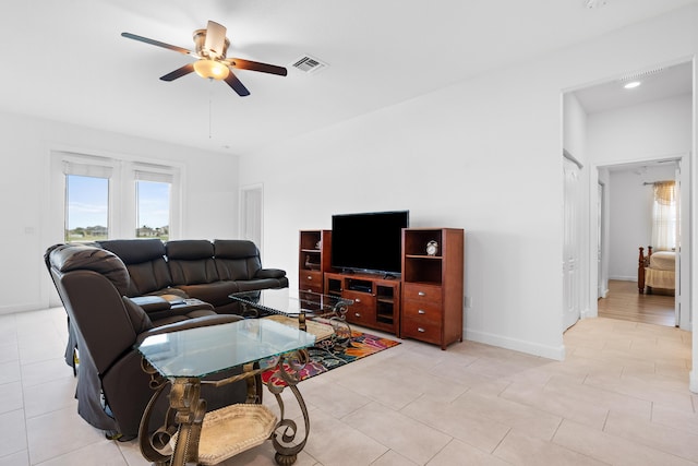 living room featuring ceiling fan and light tile patterned floors