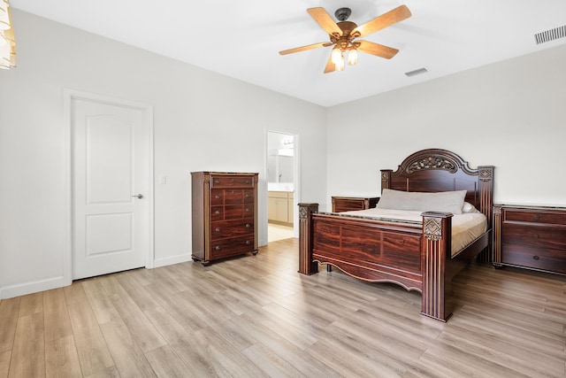 bedroom featuring ensuite bath, light hardwood / wood-style floors, and ceiling fan